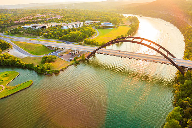 Pennybacker 360 bridge, Colorado River, Austin Texas, aerial panorama Panoramic aerial view from helicopter of 360 bridge on Colorado River near Austin Texas, looking west at sunset. austin texas stock pictures, royalty-free photos & images