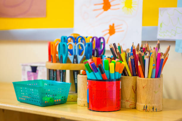 Pens on the kindergarten desk Colouring pens, scissors, pencils on the table in nursery preschool stock pictures, royalty-free photos & images