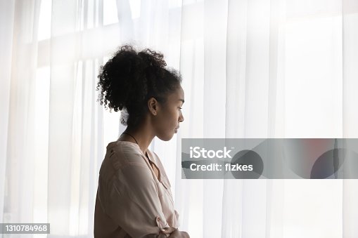 istock Pensive African American woman look in distance thinking 1310784968