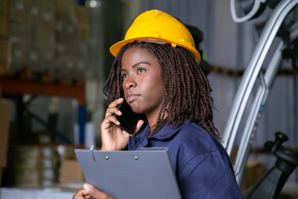 Pensive Black female engineer in hardhat stock photo