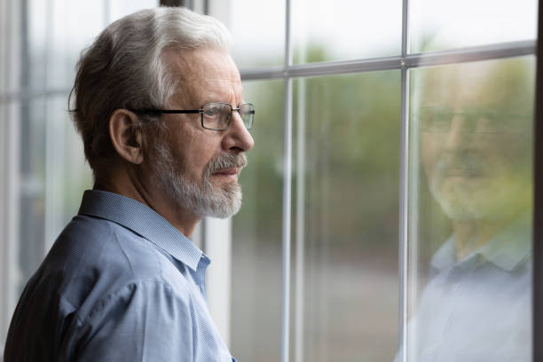 Pensive elderly mature senior man in eyeglasses looking in distance. Pensive elderly mature senior man in eyeglasses looking in distance out of window, thinking of personal problems. Lost in thoughts elderly middle aged grandfather suffering from loneliness, copy space 65 69 years stock pictures, royalty-free photos & images