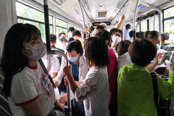 Peopel commuting on bus to work in the morning of working day amid coronavirus pandemic in Beijing, China. stock photo