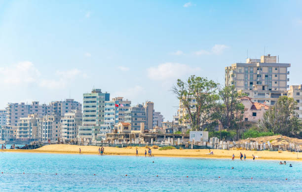 People are enjoying a sunny day on a beach in front of Varosia district of Famagusta, Cyprus People are enjoying a sunny day on a beach in front of Varosia district of Famagusta, Cyprus varosha cyprus stock pictures, royalty-free photos & images