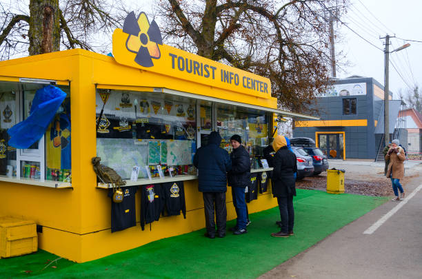 People are near tourist information center and souvenir shop in front of checkpoint Dityatki in Chernobyl NPP alienation zone, Ukraine stock photo