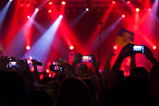 People at concert shooting video or photo. stock photo