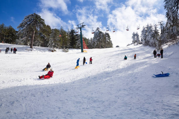 People at ski lift resort Troodos, Cyprus- January 12, 2019 - People at ski lift resort on the mountain range. mt olympus stock pictures, royalty-free photos & images