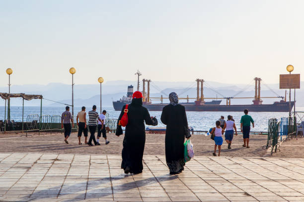 People at waterfront in Aqaba stock photo