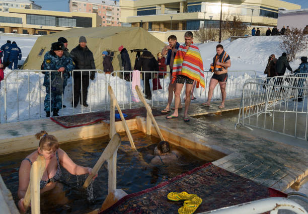 people bathe into cold water of ice-hole on epiphany day. - ice bath in natural frozen lake bildbanksfoton och bilder