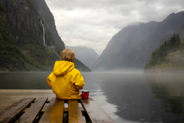 People, children enjoying the amazing views in Norway to fjords, mountains and other beautiful nature stock photo