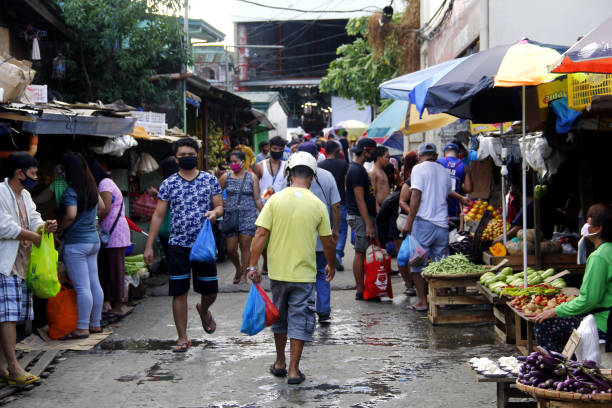 People crowd the street and market after quarantine rules eased up during Covid 19 virus outbreak stock photo