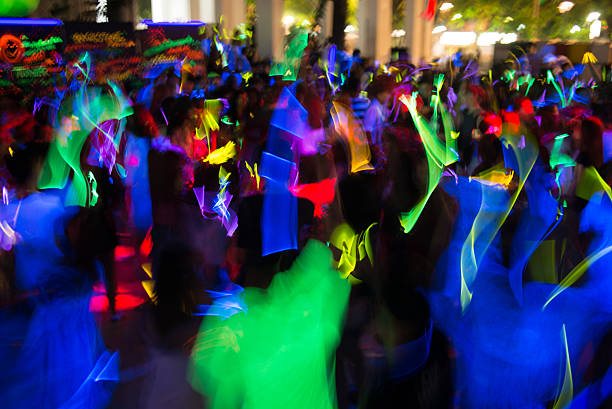 People dancing in a glow in the dark party stock photo