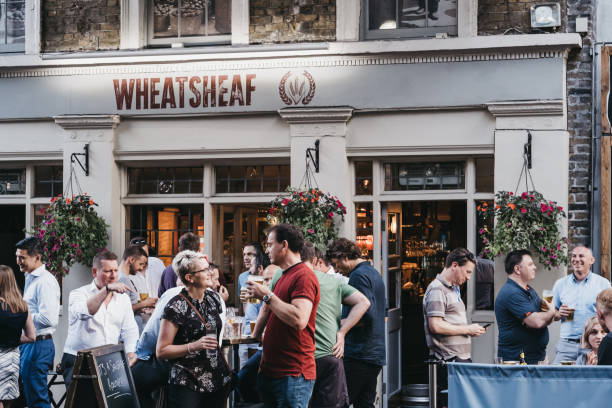 People drinking outside Wheatsheaf pub in Borough Market, London, UK. stock photo