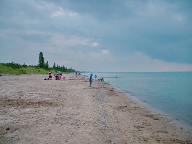 People enjoy the beach on Lake Huron at the Pinery Provincial Park. stock photo