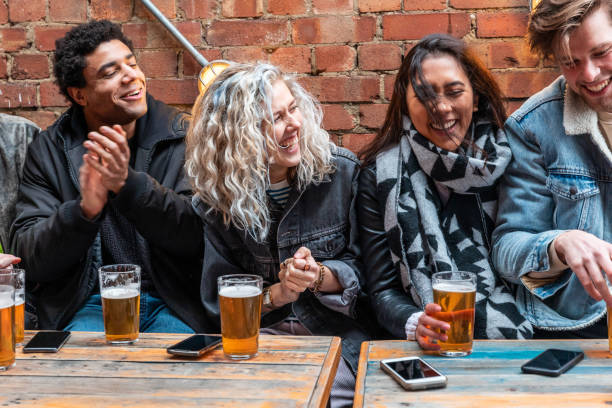 People enjoying a beer together at pub brewery stock photo
