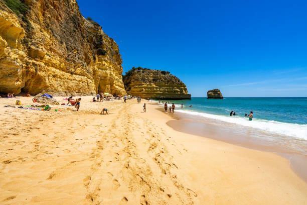 People enjoying a sunny day at Marinha Beach (Praia da Marinha), a beautiful sandy beach in Algarve, Lagoa, Portugal stock photo