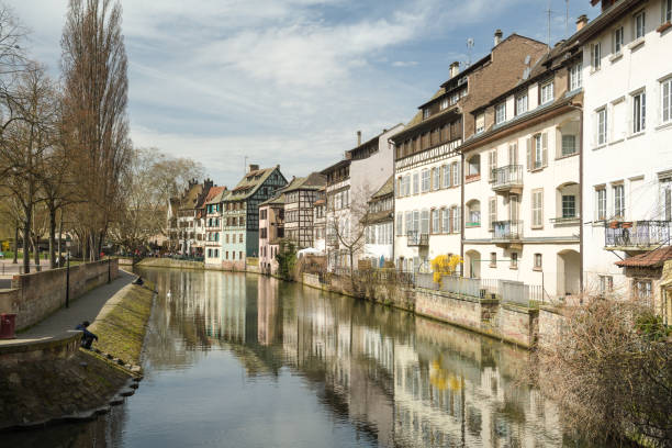 People enjoying beautiful sunny afternoon in Little France district in Strasbourg Strasbourg, France - April 03, 2018: People enjoying beautiful sunny afternoon in Little France district in Strasbourg, France during spring 2018 bas rhin stock pictures, royalty-free photos & images