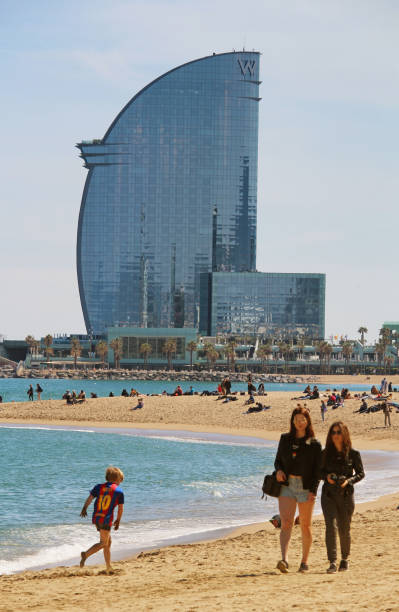 People enjoying warm spring on Barceloneta beach Barcelona, Spain - April 28, 2017: People enjoying the warm spring weather on Barceloneta beach messi stock pictures, royalty-free photos & images