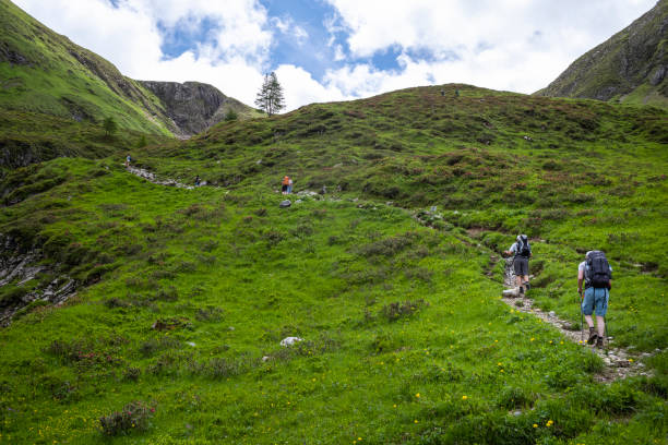 People hike Austrian Alps stock photo
