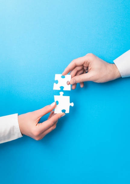 People holds in hand a jigsaw puzzle. Business solutions, success and strategy. stock photo