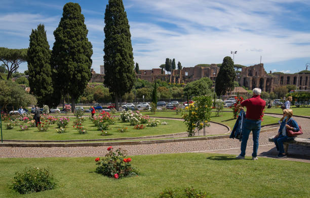 People in masks and without in rose garden in Rome during second year of coronavirus epidemic (covid-19), Italy stock photo