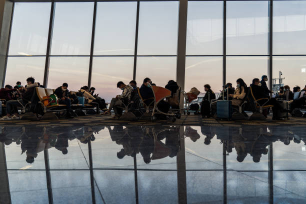 People in masks sitting in the Beijing Daxing International Airport terminal stock photo