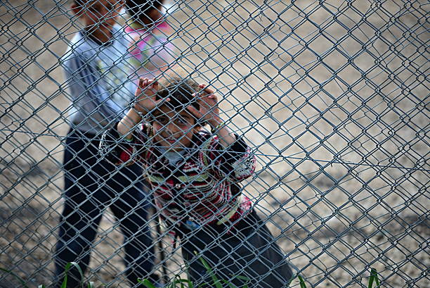 people in refugee camp stock photo
