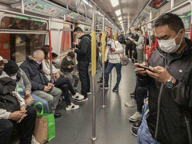 People inside subway cover their faces with masks during the Coronavirus Covid19 health crisis in Hong Kong Hong Kong, China January 27th 2020 : People inside subway cover their faces with masks during the Coronavirus Covid19 health crisis in Hong Kong aluxum stock pictures, royalty-free photos & images
