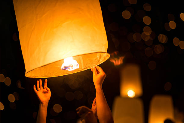 People is launching sky lantern People is launching sky lantern to the sky chinese lantern stock pictures, royalty-free photos & images