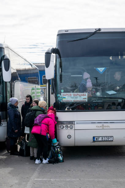 People leaving Ukraine by bus to Warsaw stock photo