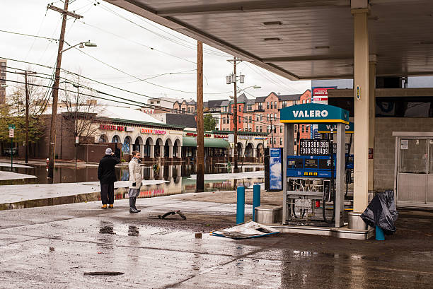 People on a damaged gasoline station after Hurricane Sandy "Hoboken, New Jersey, USA - October 31, 2012: People on a damaged gasoline station after Hurricane Sandy" new jersey street flooding stock pictures, royalty-free photos & images