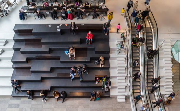 People on the steps and escalators in the Groninger Forum stock photo