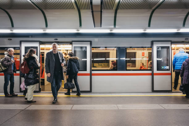 People on the underground platform in Vienna, Austria, train with open doors on the background. stock photo