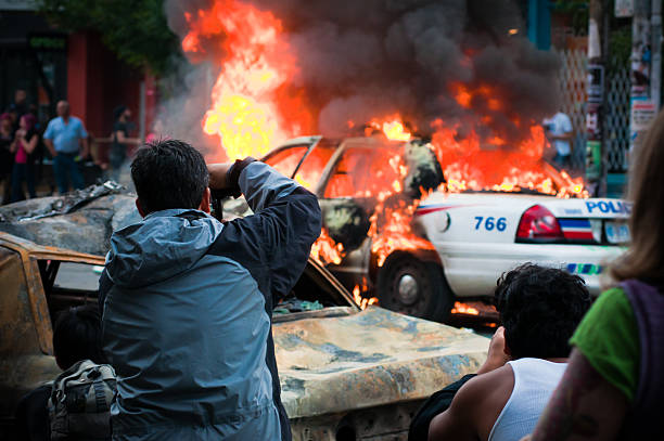 People photographing a fire  riot stock pictures, royalty-free photos & images