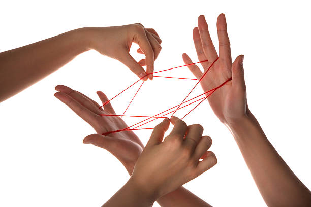 People playing cats cradle game,close-up stock photo