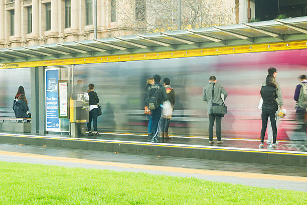 People preparing to board Adelaide tram stock photo