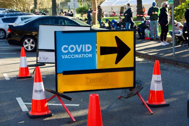 People queueing for covid-19 vaccination at walk-in coronavirus clinic in Melbourne, St Kilda during lockdown stock photo