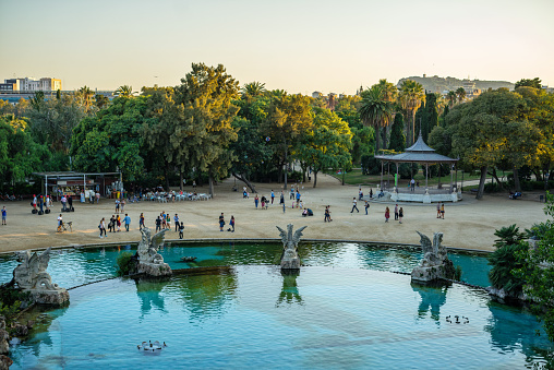 People relaxing in Parc de la Ciutadella at sunset