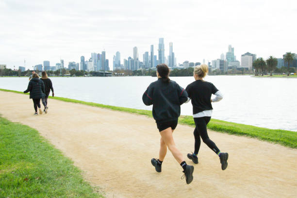 People running and walking with masks in Melbourne, Victoria, Australia during the covid-19 lockdown stock photo
