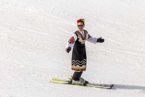 People skiing dressed with traditional bulgarian clothes. stock photo