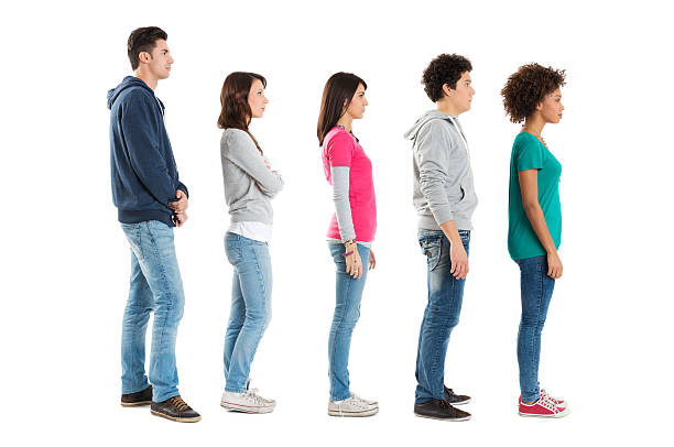 People Standing In A Row Multi Ethnic People Standing In A Row Isolated On White Background . waiting in line photos stock pictures, royalty-free photos & images