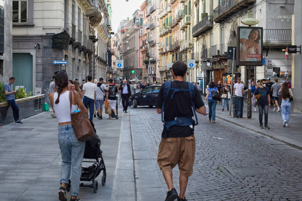 People stroll through the streets of the historic center of the city of Naples, Italy. stock photo