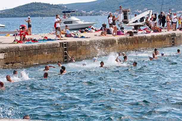 People swiming on the 5th Millenium Jump in Zadar, Croatia Zadar, Croatia - July 30, 2011: People in the sea on the 5th Millenium Jump in Zadar, Croatia lepro stock pictures, royalty-free photos & images