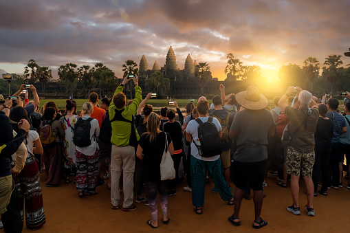 Siem Reap, Cambodia - November 15, 2019:  People take a photo in Angkor Wat temple at sunrise in Angkor Thom, Siem Reap, Cambodia