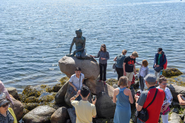 People taking pictures with the Sirenetta statue at Copenhagen on Denmark stock photo