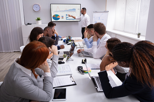 Group Of Business Executives Tired Of Long Meeting In Office