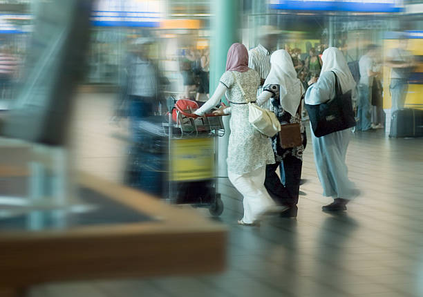 people traveling at the airport stock photo