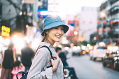 Walking young adult asian woman traveller backpack. People traveling in city lifestyle chinatown street food market Bangkok, Thailand. Staycation summer trip concept. Bokeh on background.