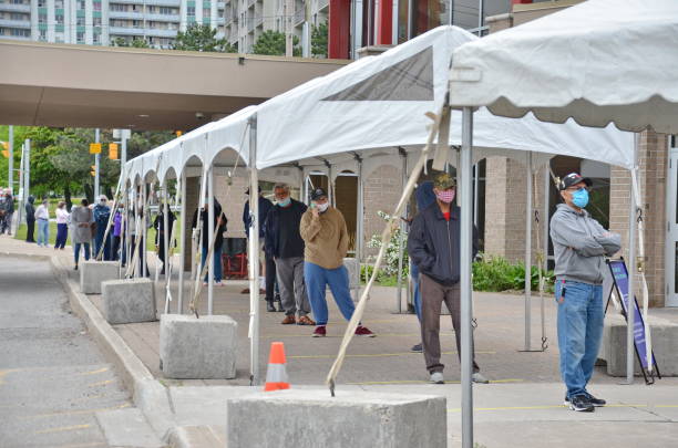 People wait in line for a Covid-19 test in Scarborough, Ontario. stock photo