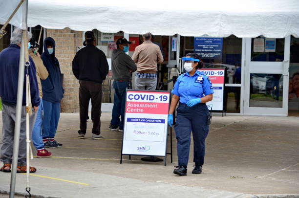 People wait in line for a Covid-19 test in Scarborough, Ontario. stock photo
