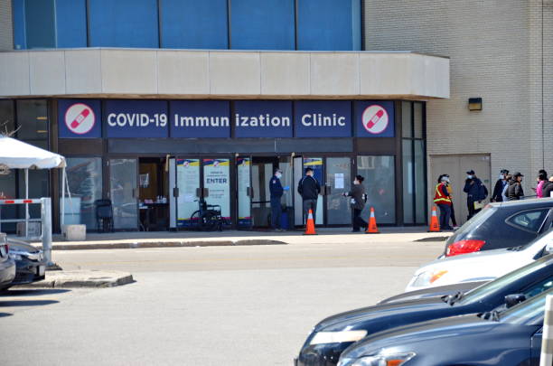 People wait in line for a Covid-19 vaccine at the City of Toronto Vaccination Clinic stock photo